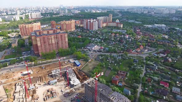 Drone flies over a construction site near Moscow. Construction cranes in the industrial zone. 