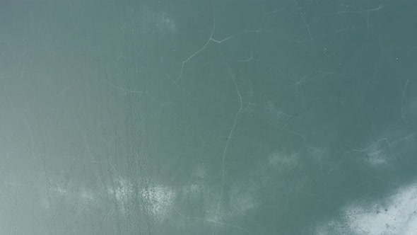 AERIAL: Flying Over Frozen Lake with Fractured Ice alt
