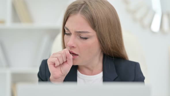 Close Up of Young Businesswoman Coughing at Work alt