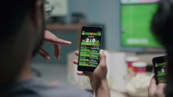 Crop Men Making Bets During Soccer Match alt