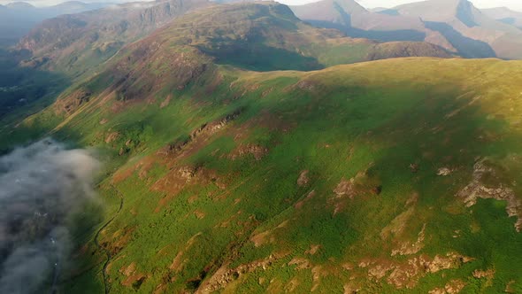 Flight over Catbells with a cloud inversion just after sunrise. Aerial footage from the summit with alt