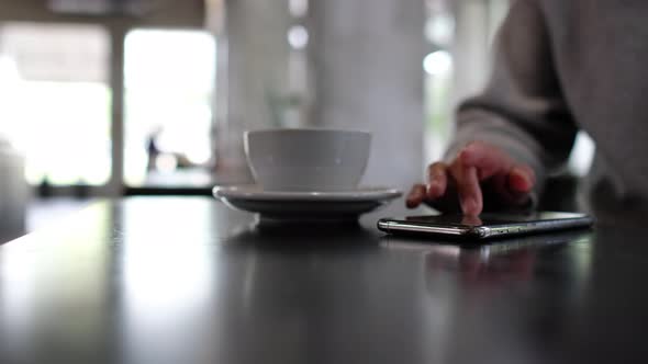 Closeup of a woman touching and scrolling on smart phone screen