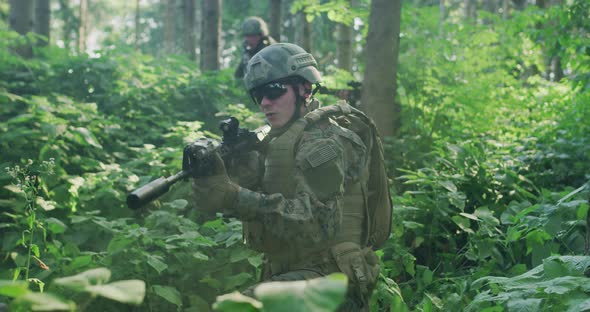 Soldiers Holding Rifles Ambushed in Dense Fores During Day Time Protecting Base with Full Tactical alt