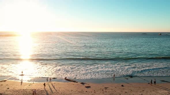 Scenic Aerial Footage of a Beach and Calm Ocean Waters During a Dramatic Sunset