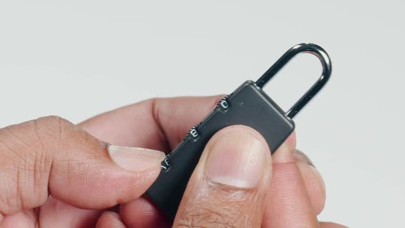 Fingers Hold A Combination Lock