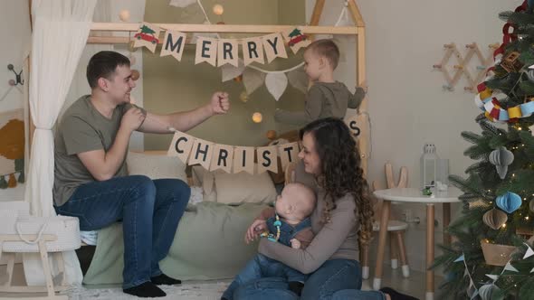 Young Family Preparing for Celebrating Christmas alt