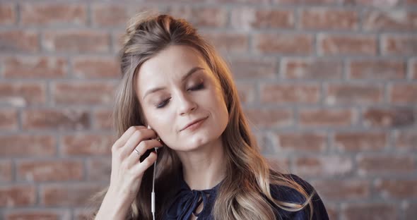 Happy Beautiful Blonde Woman Talking To Her Friend on the Phone and Kissing It in the End. alt