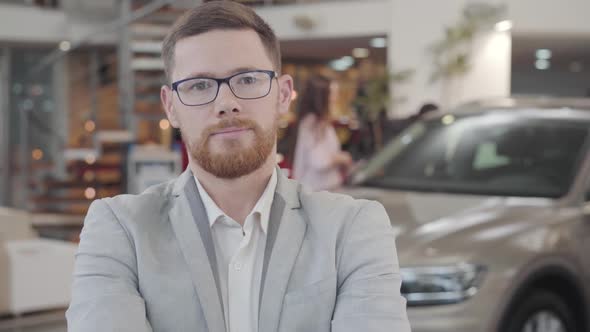 Close-up Face of Young Caucasian Car Dealer Gesturing Yes By Shaking Head and Smiling alt