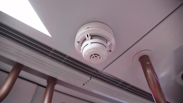 Closeup of Smoke Alarm on the Ceiling of Subway Car