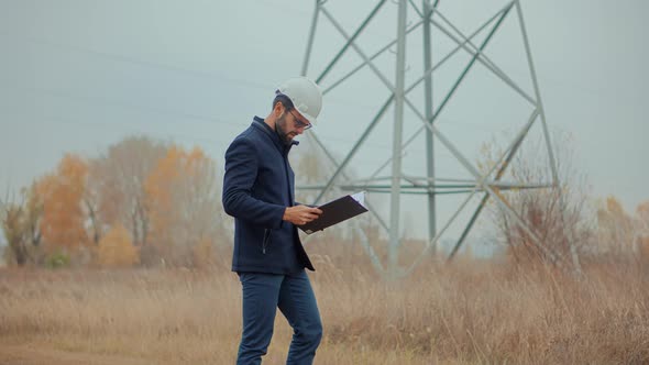 Power Station Electrical Energy High Voltage. Electricity Worker On High Voltage Tower. Power Line. alt
