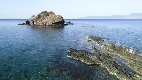 Aerial Top View of Cliff Rocks in a Blue Ocean alt