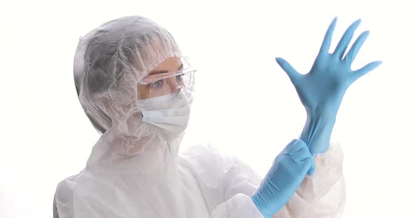 Woman is Dressing on Protective Suit Mask Gloves and Glasses
