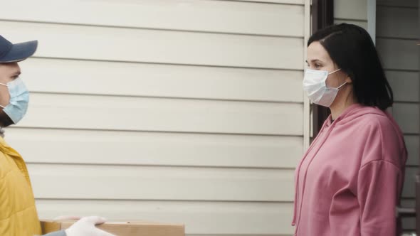 Postman or Delivery Man Carry Small Box Deliver to Young Woman Customer at Home alt