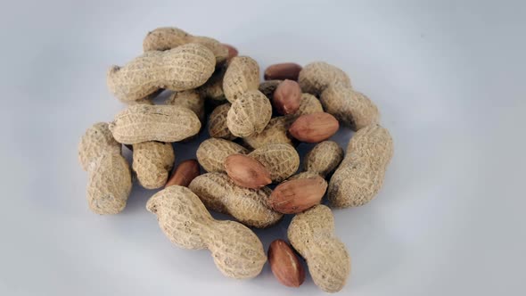 Peanuts rotating on white background - shelled peanuts
