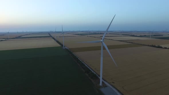 Landscape with Windmills and Farm Fields at Dusk. Aerial Survey alt