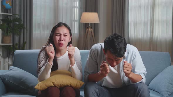 Upset Young Asian Couple Is Frustrated About The Loss Of The Team In Game They Are Watching Tv alt