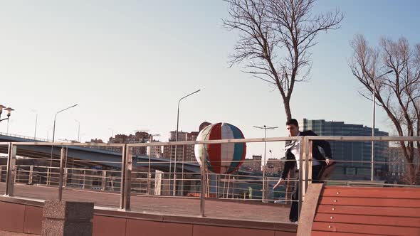 Businessman in Jacket and Tie Jumps Over an Obstacle on Background City alt
