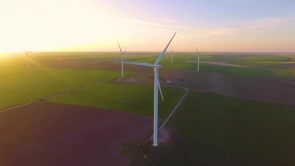 Wind Turbine Farm on Beautiful Evening Landscape. Renewable Energy Production for Green Ecological