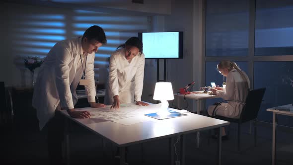 Multiracial Electronics Development Engineers Engineers Discussing Control Electronics Scheme in alt