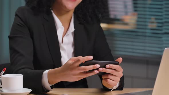 Portrait of African American Woman Texting on Smartphone Happy to Receive Good News Celebrating alt