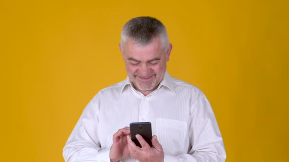 Handsome adult man uses smartphone texting messages in social media alt