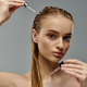 Elegant Woman Grooming Her Long Hair - PhotoDune Item for Sale