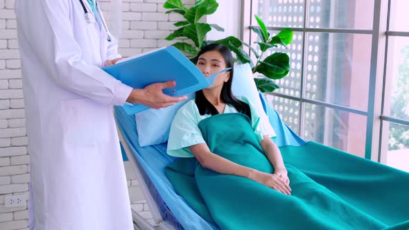 Doctor in Professional Uniform Examining Patient at Hospital alt