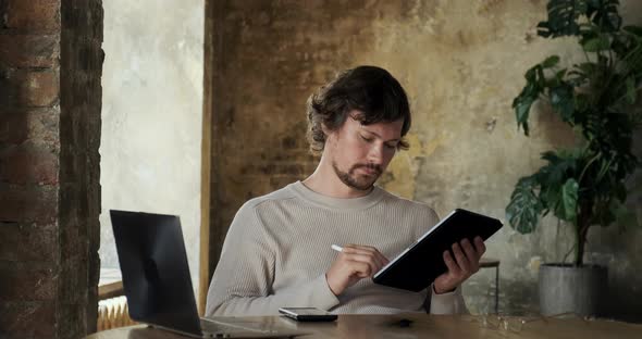 Male Freelance Artist Using Digital Tablet with Electronic Pencil