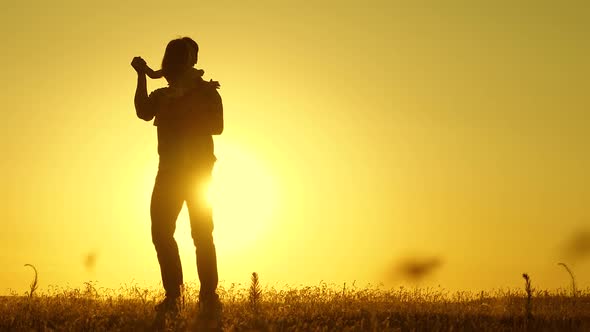 Concept of a Happy Childhood. Dad Is Dancing with a Child in Her Arms in Field in Sun alt