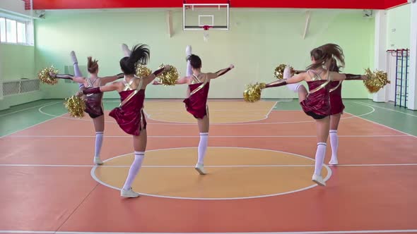 Cheerleaders Performing in School Gym alt