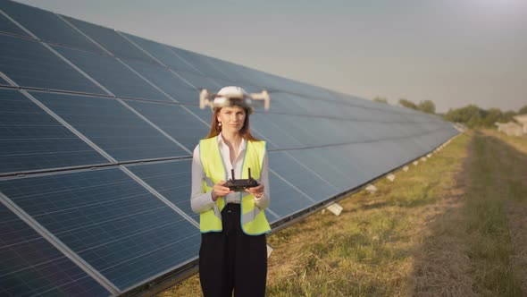 Engineer Woman in Hardhat Holding Tablet Computer Operating Flying Drone in alt