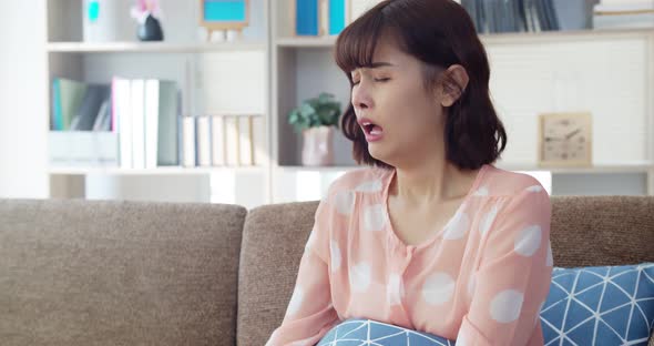 Asian young woman feeling itchy nose and sneezing 