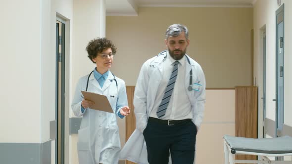 Doctor and his assistant going through corridor