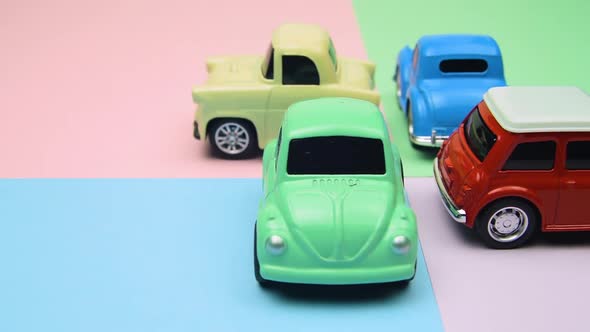 Four Toy Cars Close On Differet Colored Surfaces