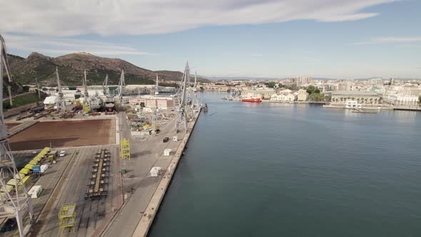 Industrial harbour port cranes, Cartagena, Spain. Aerial pullback. Heavy equipment concept