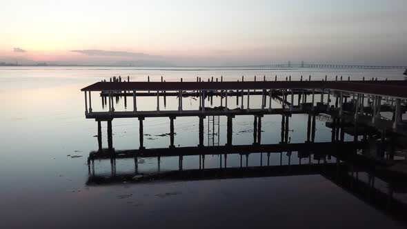 Reveal shot of Penang Bridge from fisherman pier at Penang, Malaysia. alt