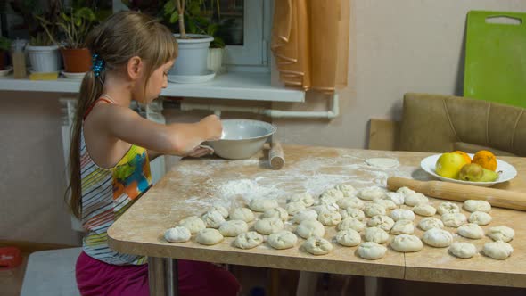 A girl is cooking meat pies alt