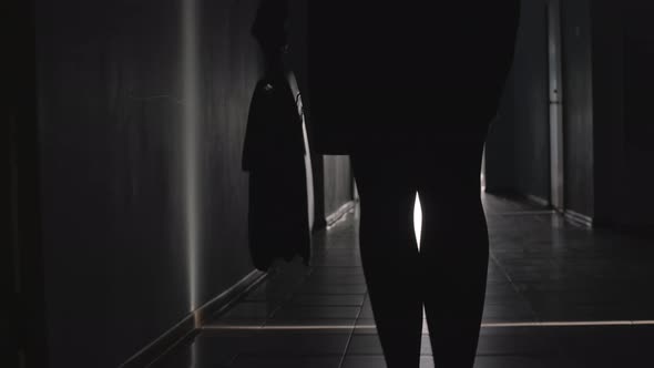 Silhouette of Legs of Business Lady Walking along Corridor