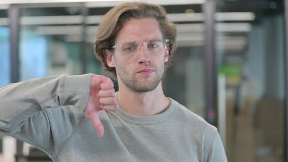 Portrait of Thumbs Down Gesture By Young Businessman alt
