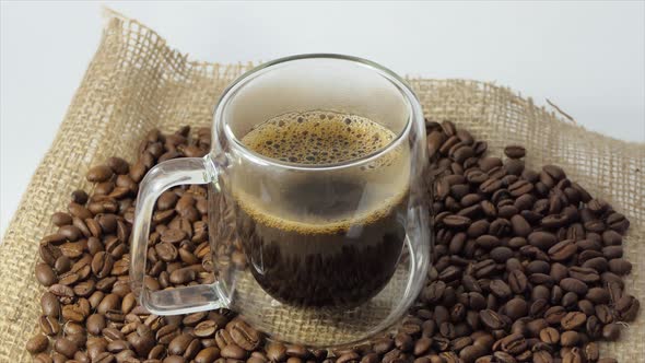 Cup of Coffee with Fresh Roasted Coffee Beans Background