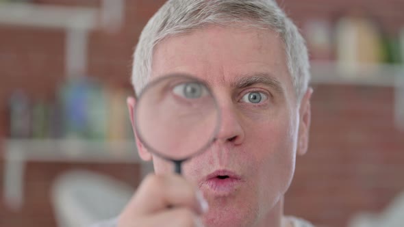 Funny Senior Old Man Using Magnifying Glass  alt
