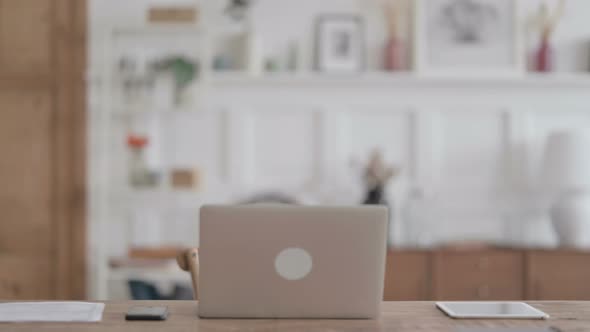 African Man Coming Back Opening Laptop in Office alt