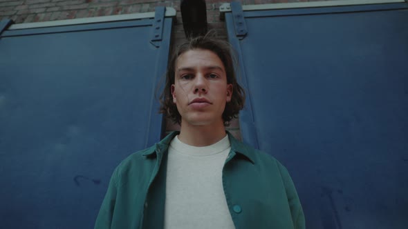 Confident Guy with Trendy Haircut Posing Outdoors alt
