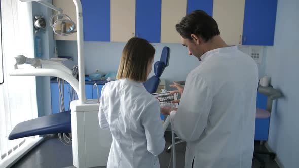 Back View of Dental Coworkers Using Tablet Pc alt