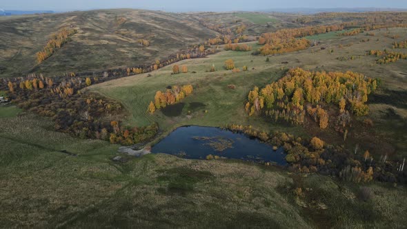 Aerial View of Blue Lakes and Green Forests on a Sunset Autumn Day