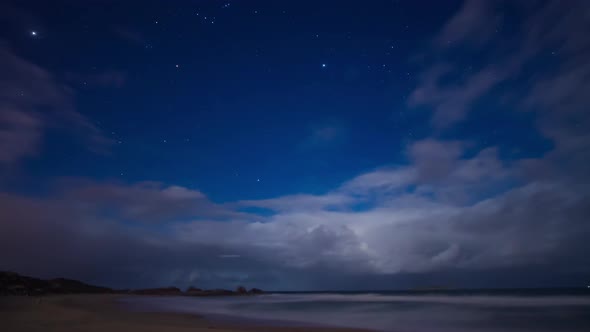 Time lapse - Night with stars and clouds at 'Praia mole' beach.
