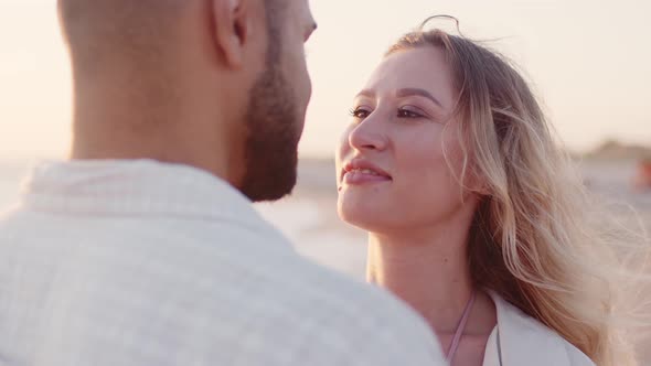 Young Couple in Love Looking at Each Other at the Beach