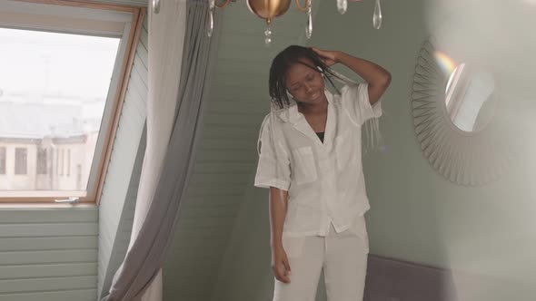 African American Woman Enjoying Music at Home alt