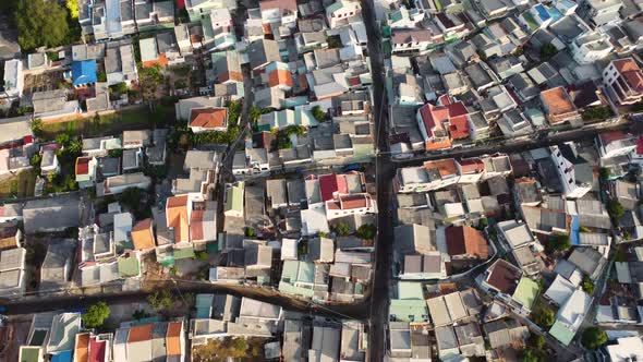Vast dense living area buildings and narrow streets of Mui Ne town in Vietnam, aerial view alt