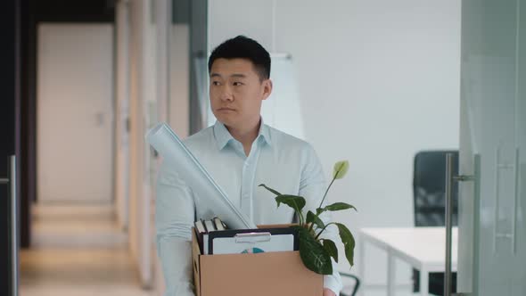 Upset Middle Aged Asian Man Manager Carrying Box with Personal Belongings and Looking Sadly at His alt